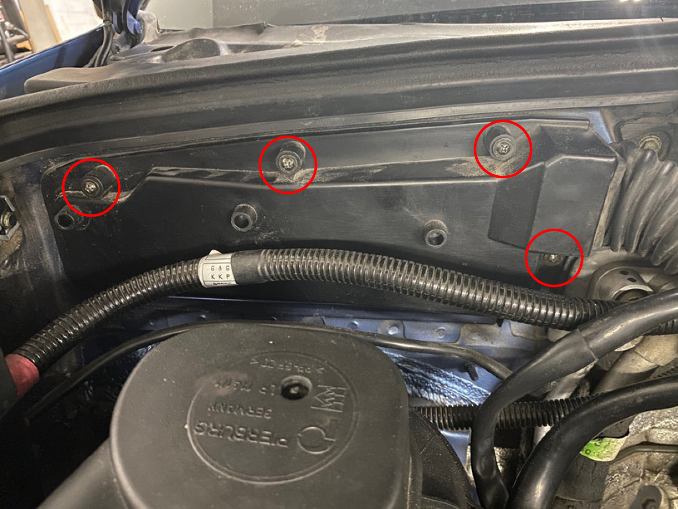 BMW E36 ECU cover screw locations circled.