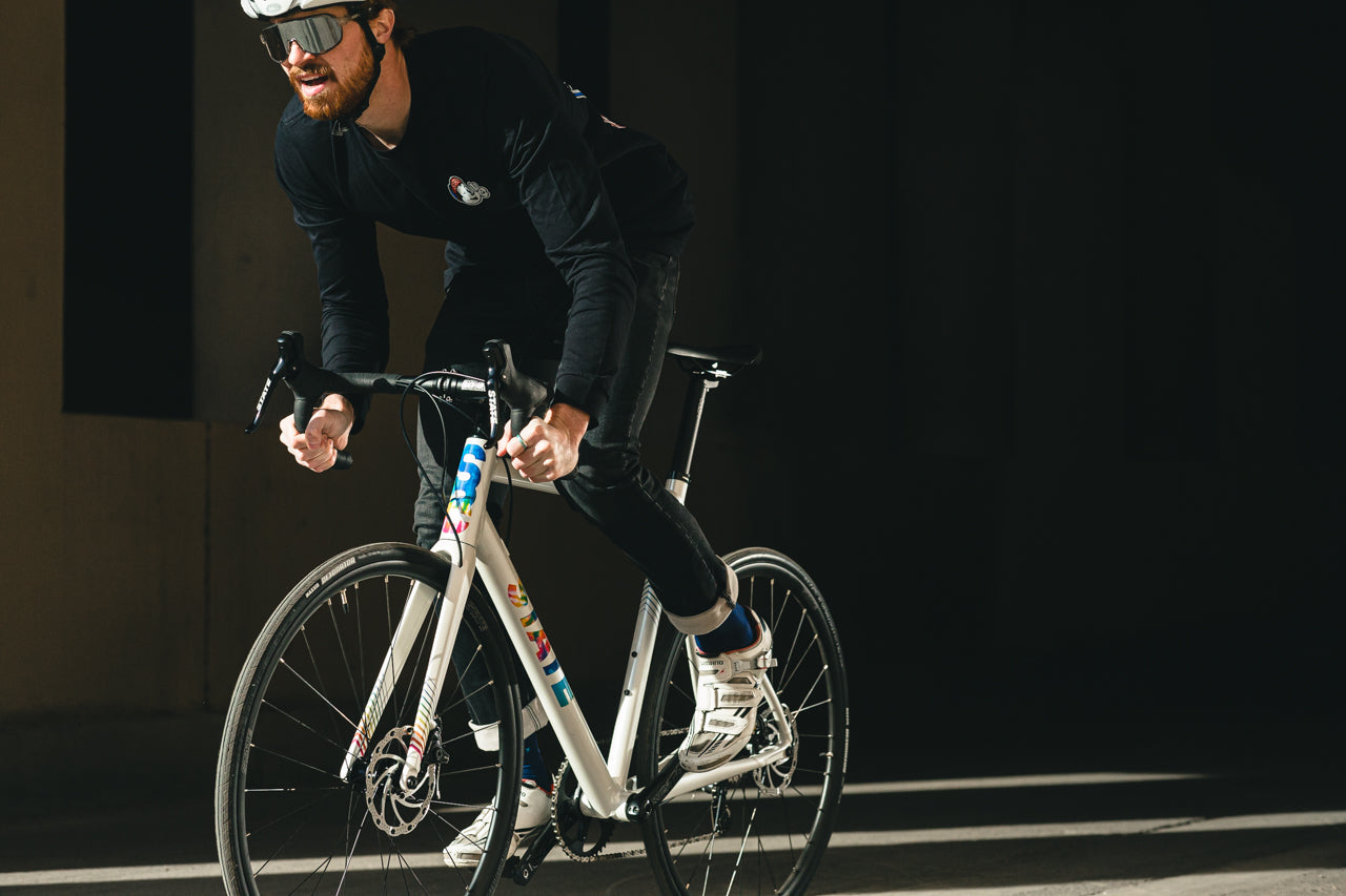 cyclist wearing black riding the undefeated Disc endurance Road bike