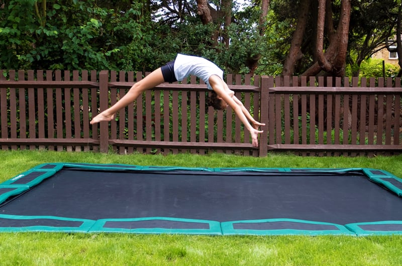 Minnie doing flip on trampoline