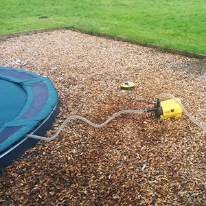 Above ground pump for trampoline drainage
