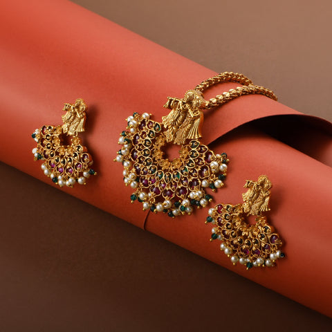 A close up image of an antique temple styled pendant set