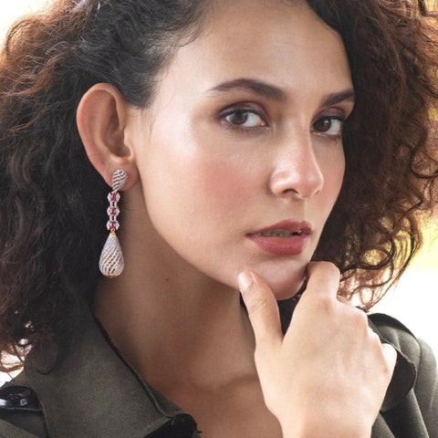 An image of a woman wearing Indian drop earrings.