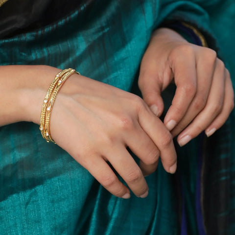 An image of a woman wearing kundan bangles.