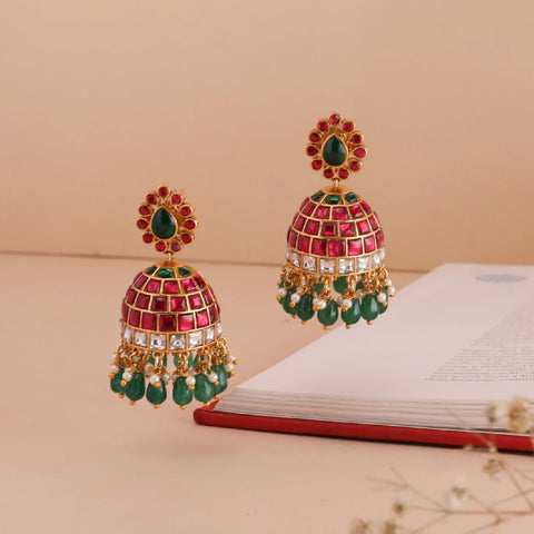 An image of Indian earrings with jadau and kempu stones with beads.