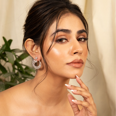 An image of a woman wearing a hoop earrings