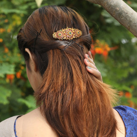 An image of an antique hair clip in a woman's hair