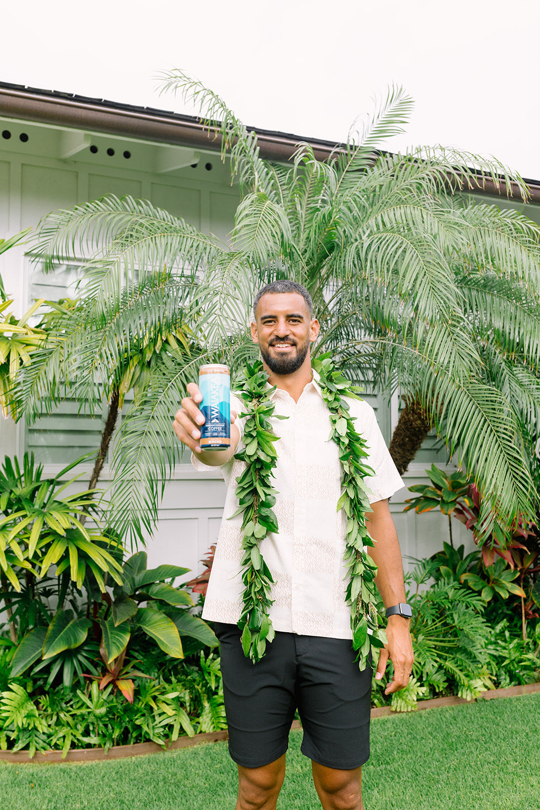 marcus holding a can of waiakea RTD coffee