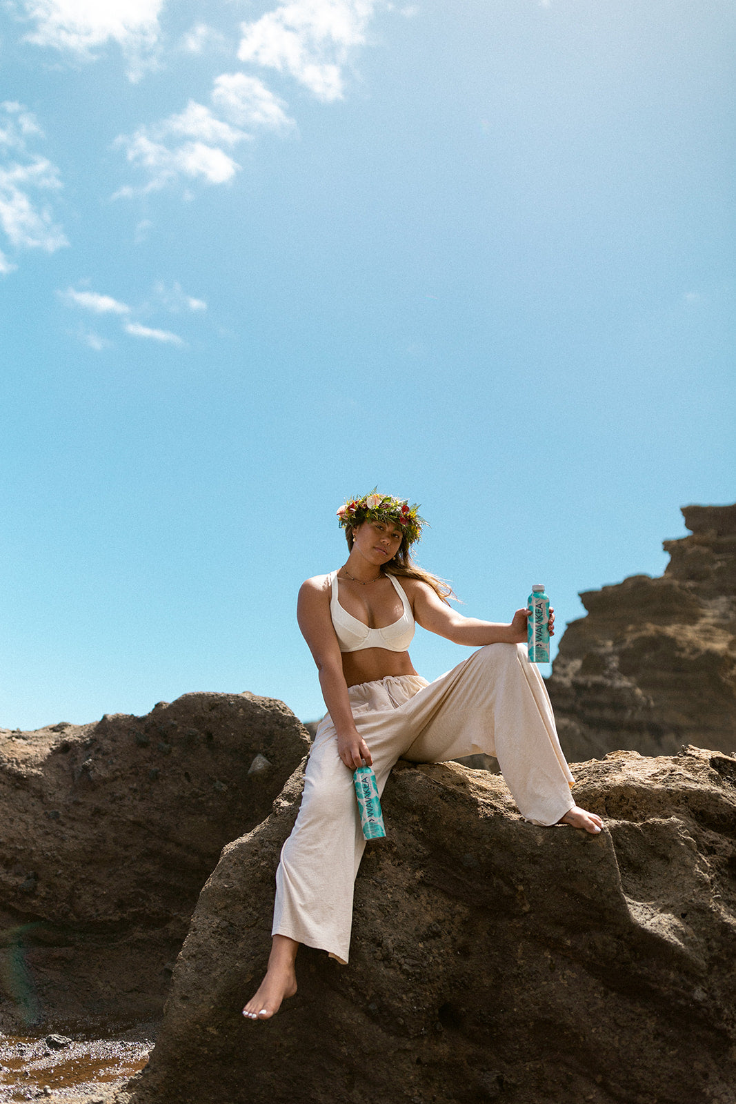 Kalei Mau sitting on rocks with Waiākea water 