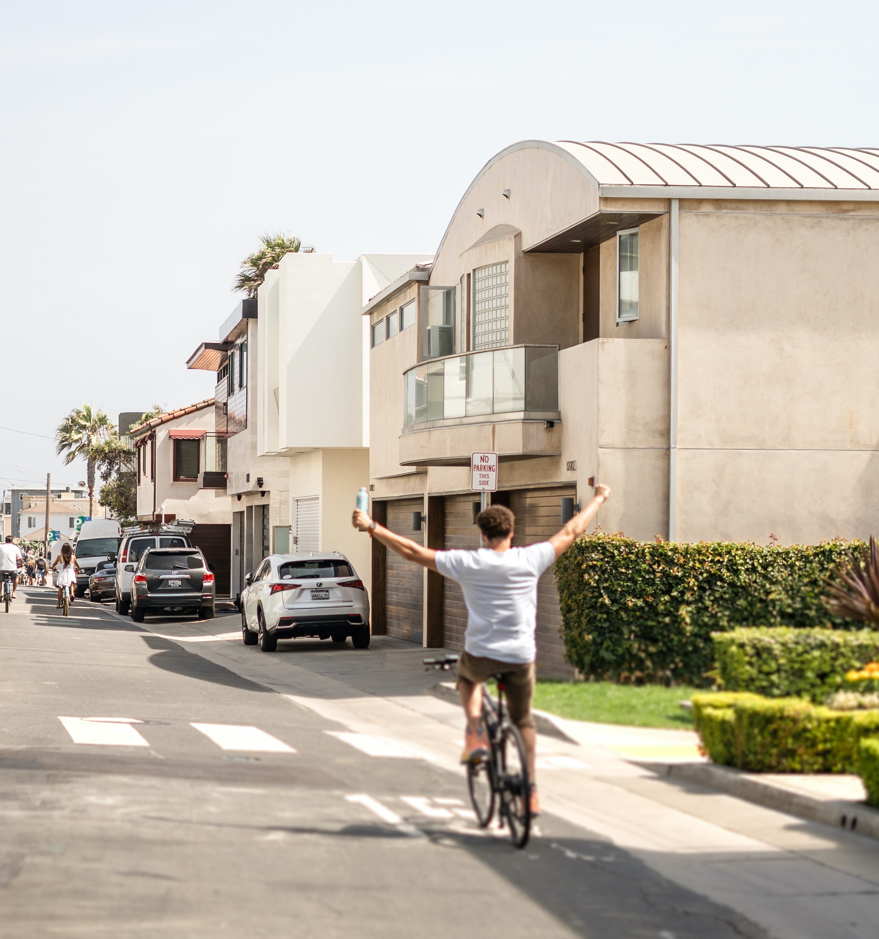 Klay Thompson riding a bike holding Waiākea water 