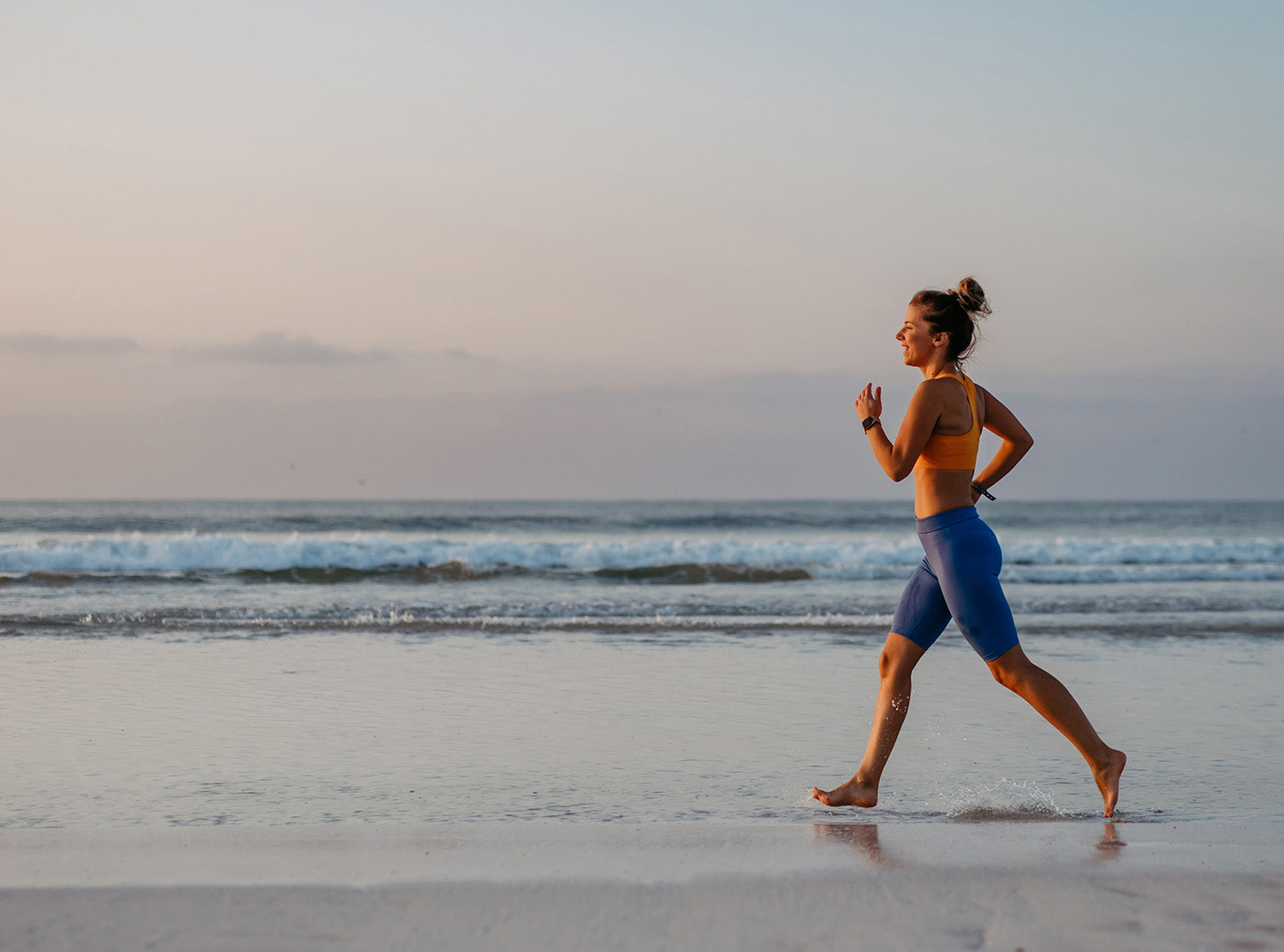 female running, energised on a beach, Nourished 