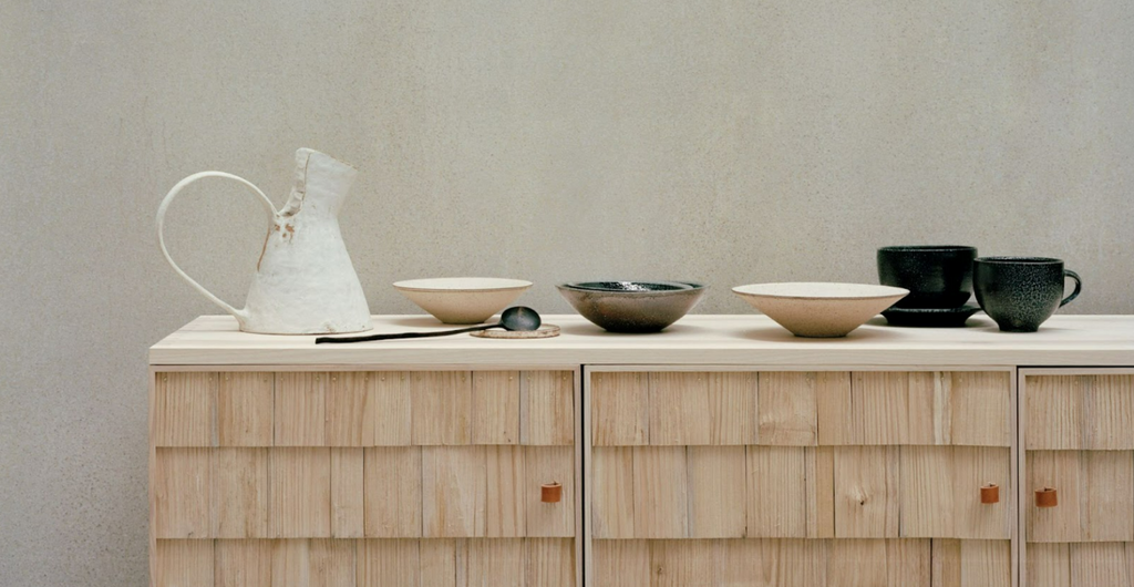 Photo of crafted tableware on wooden cabinet, photographed by Rory Gardner and styled by Sania Pell