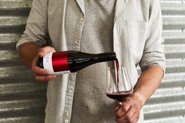 Man pouring red wine into glass