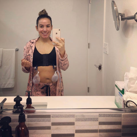 Mirror photo of Joanna wearing the front closure bra with her drains attached