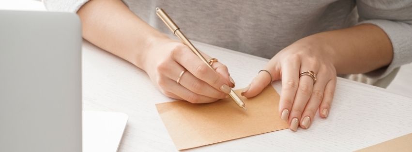 Hands beginning to write letter
