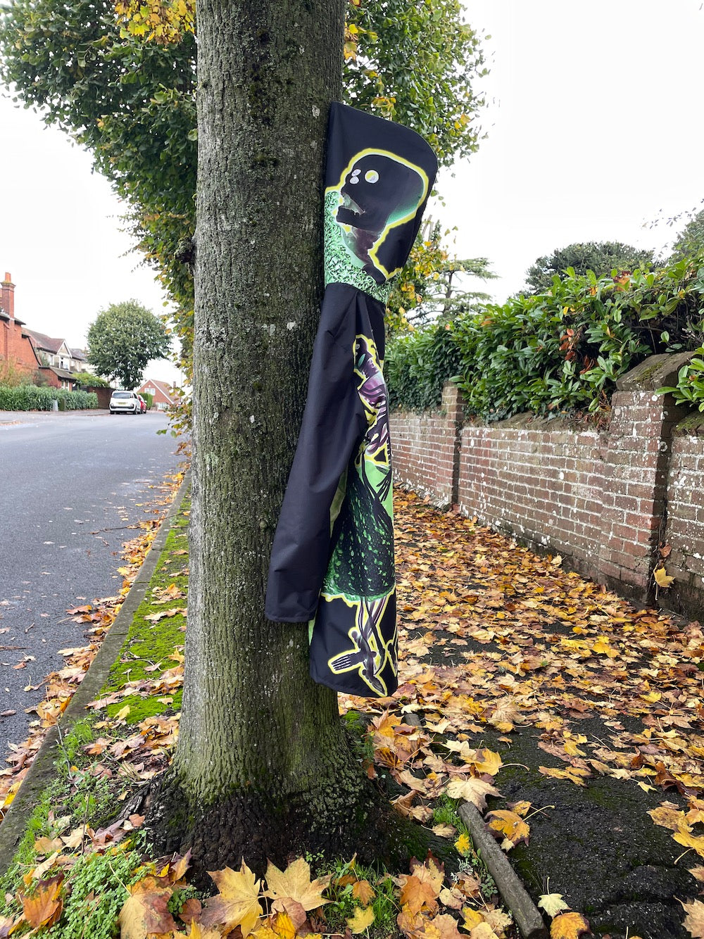 Raincoat hanging from a nobble on a tree