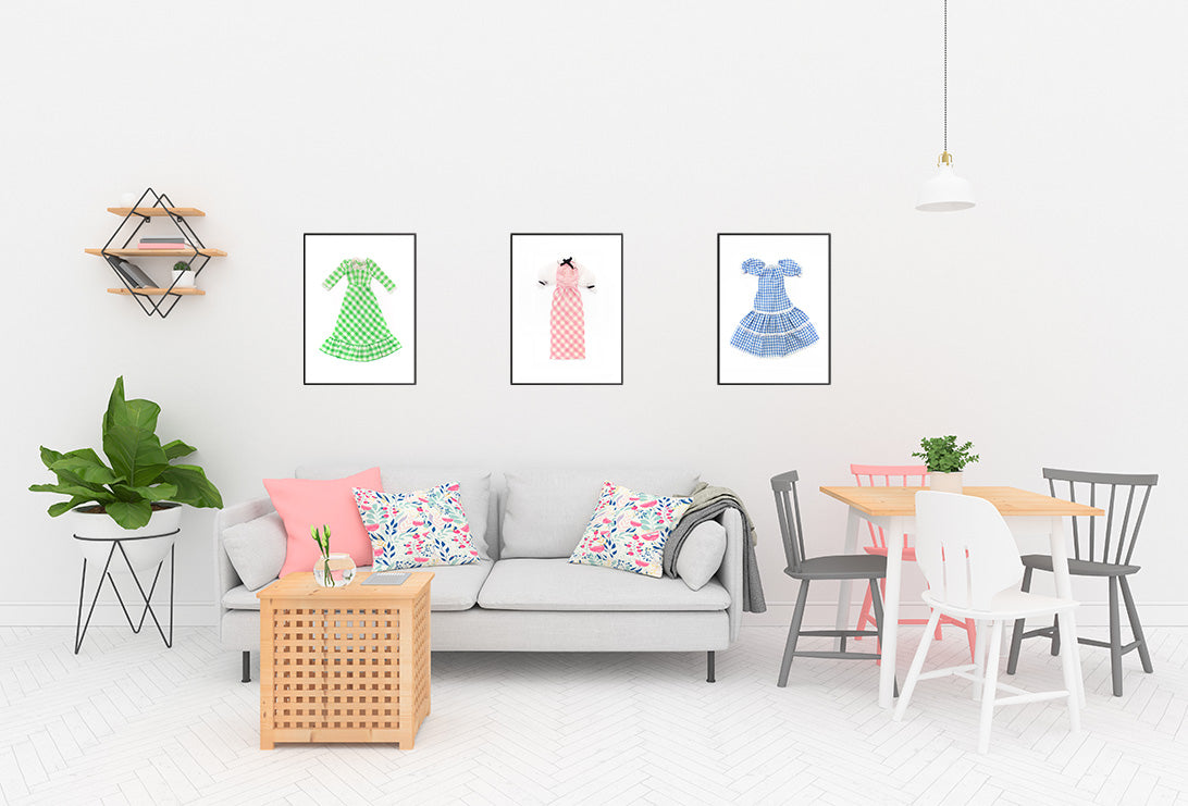 Prints of three gingham dresses in a living room