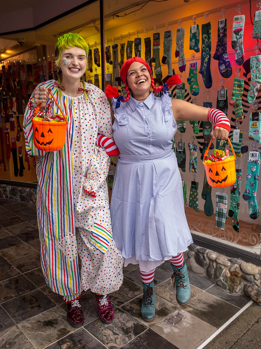 Employees Lindsey and Corinne show off their Halloween costumes in front of Cute But Crazy Socks in Bellingham, Washington