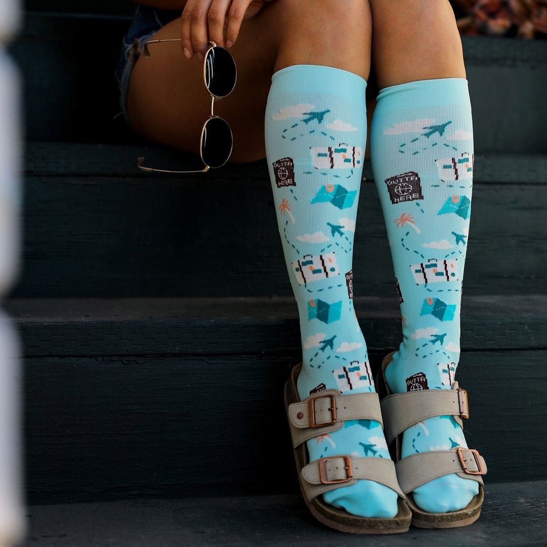 Compression socks with travel theme featuring airplanes and maps