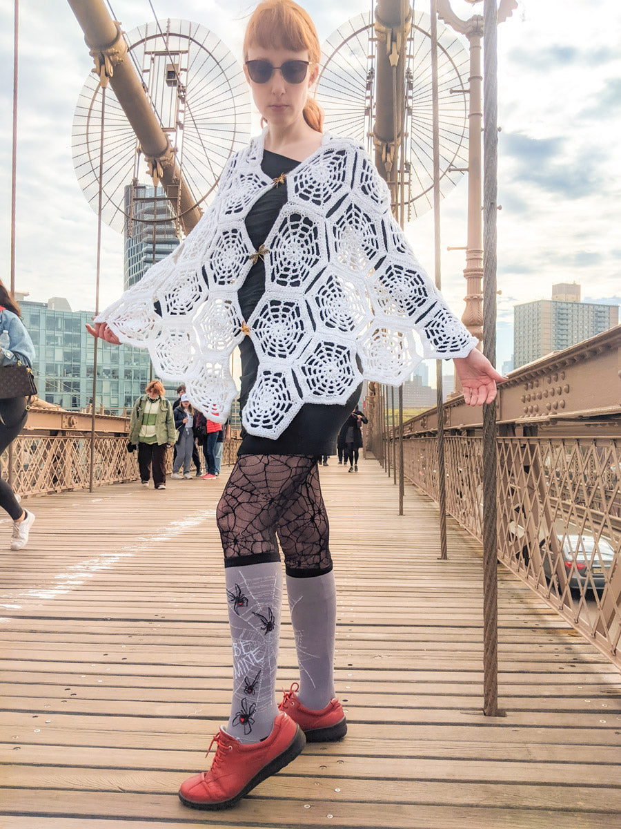 Andrea wearing her spiderweb knee socks outfit for Halloween on the Brooklyn Bridge
