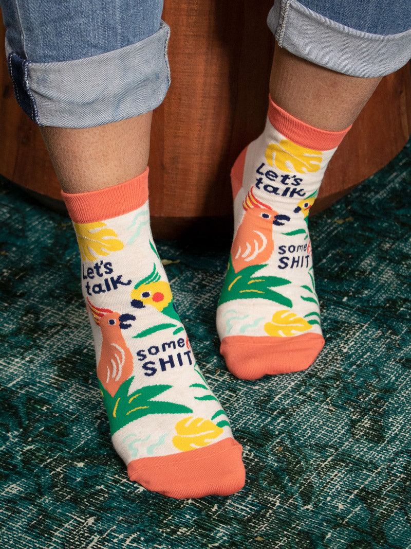 Tropical bird socks with the words "Let's Talk Some Shit"