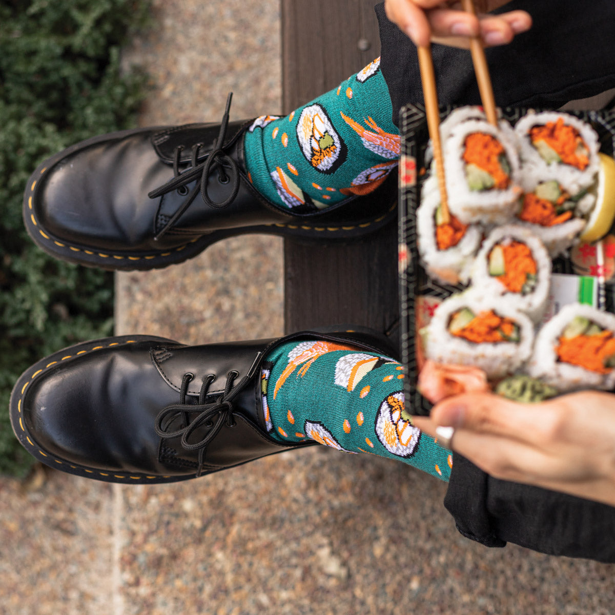 Men's sushi socks in teal and orange worn with black business casual shoes