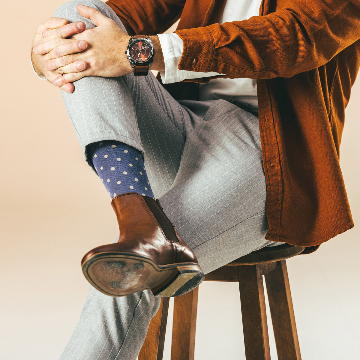 Polka dot men's socks worn with Chelsea boots and khakis