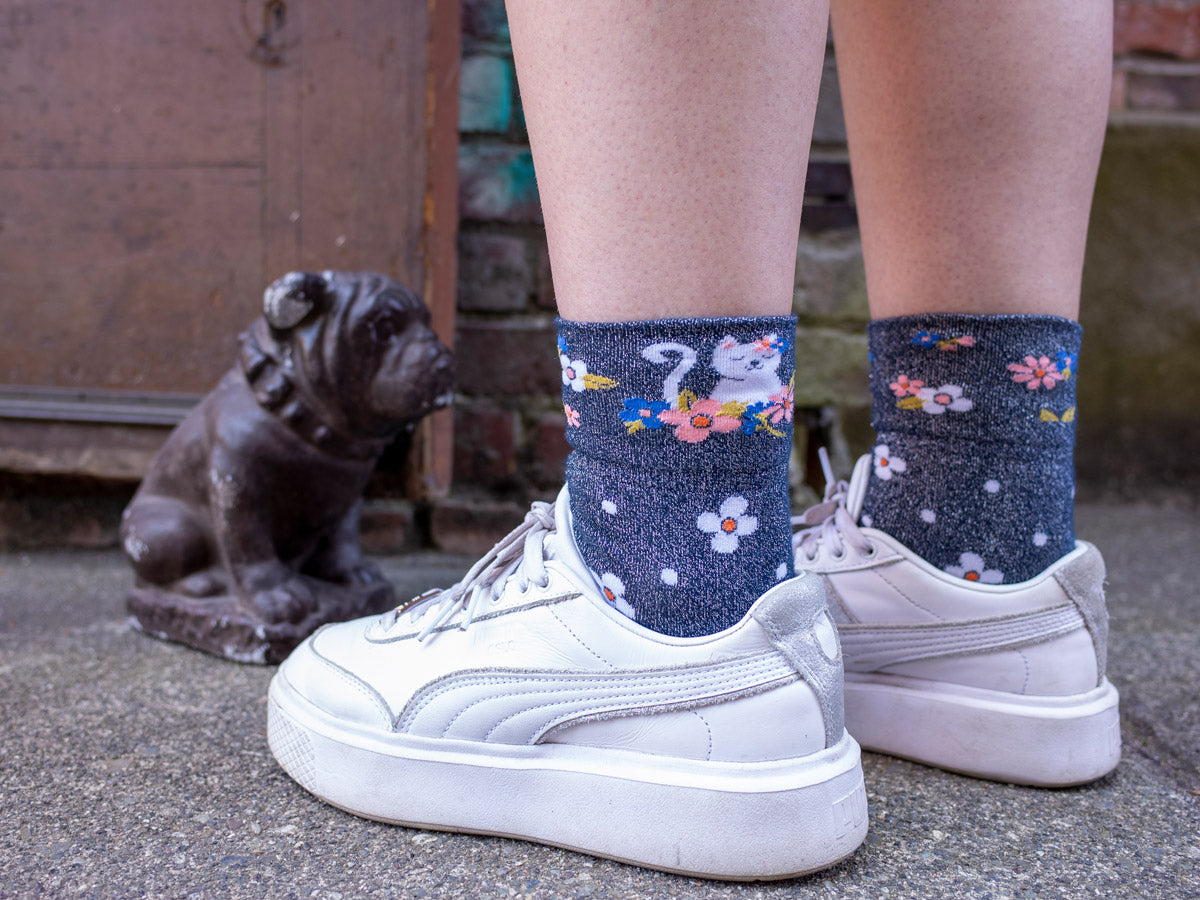 Metallic sparkly socks with cats worn with white sneakers