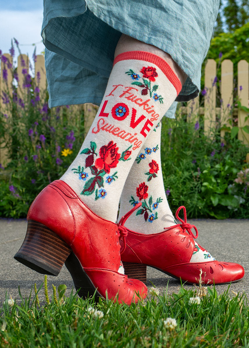 Red shoes and socks with red roses and the words "I Fucking Love Swearing"