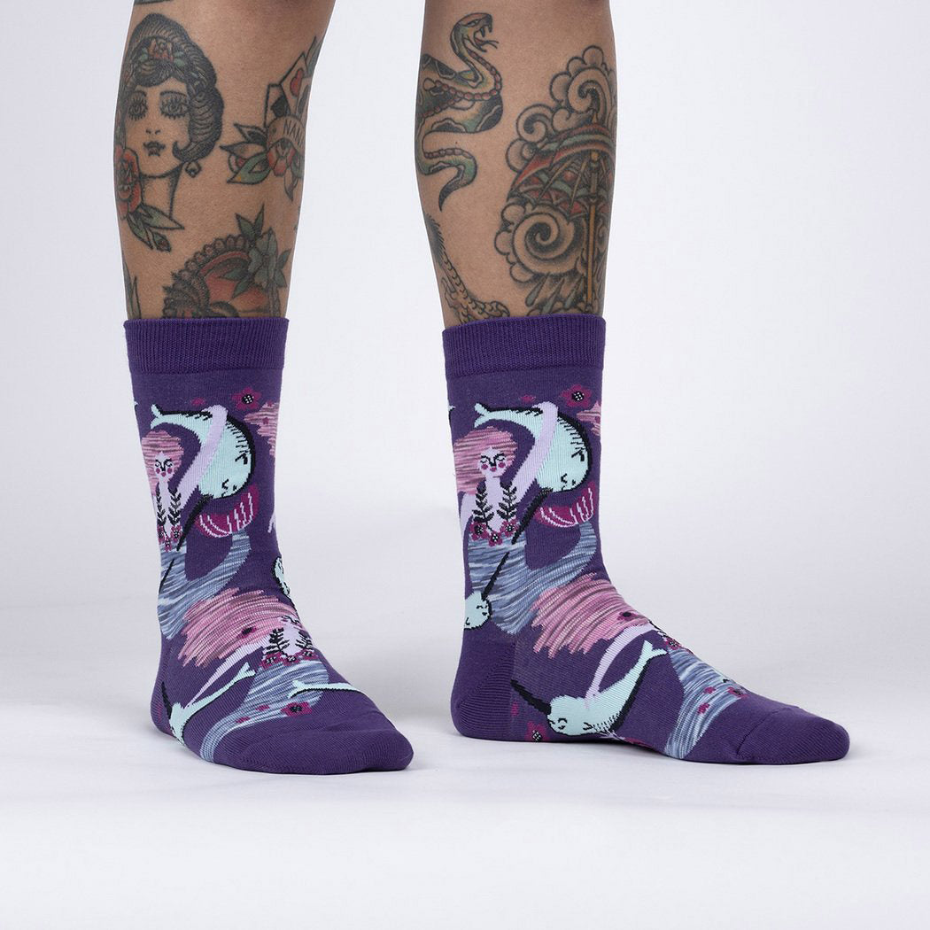 Purple socks with mermaids and narwhals swimming