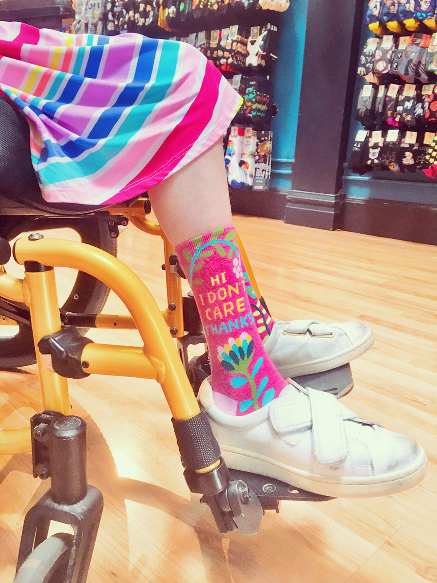 Socks that say "Hi. I don't Care. Thanks." worn by a customer at Cute But Crazy Socks