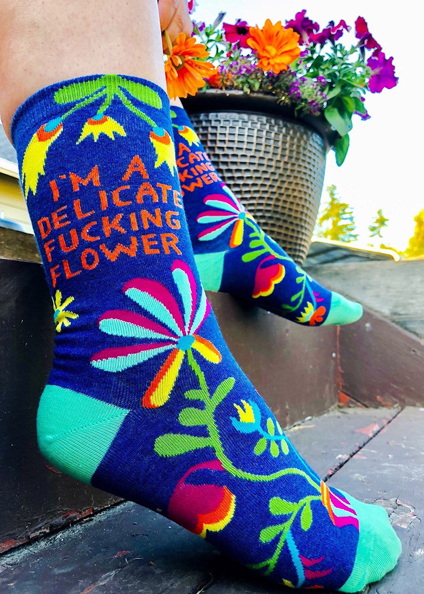 Funny socks with flowers and the words "I'm A Delicate Fucking Flower"