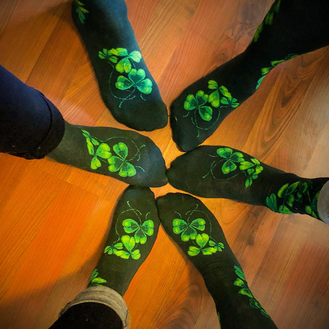 A circle of feet wearing lucky green shamrock socks by ModSocks