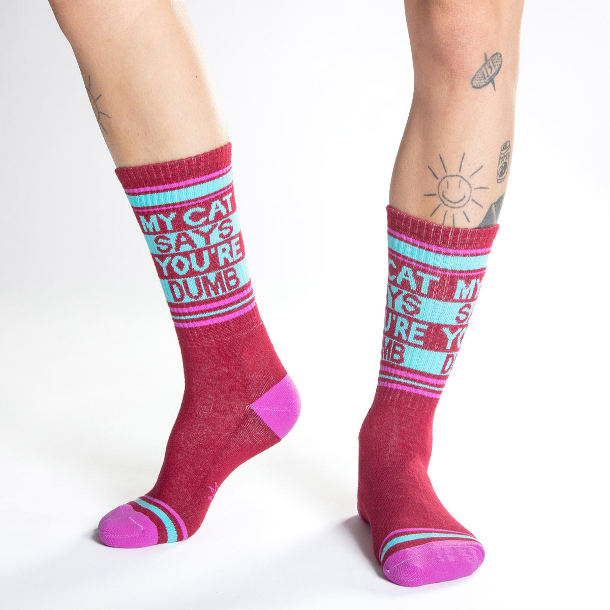 Magenta socks that say "My Cat Says You're Dumb"