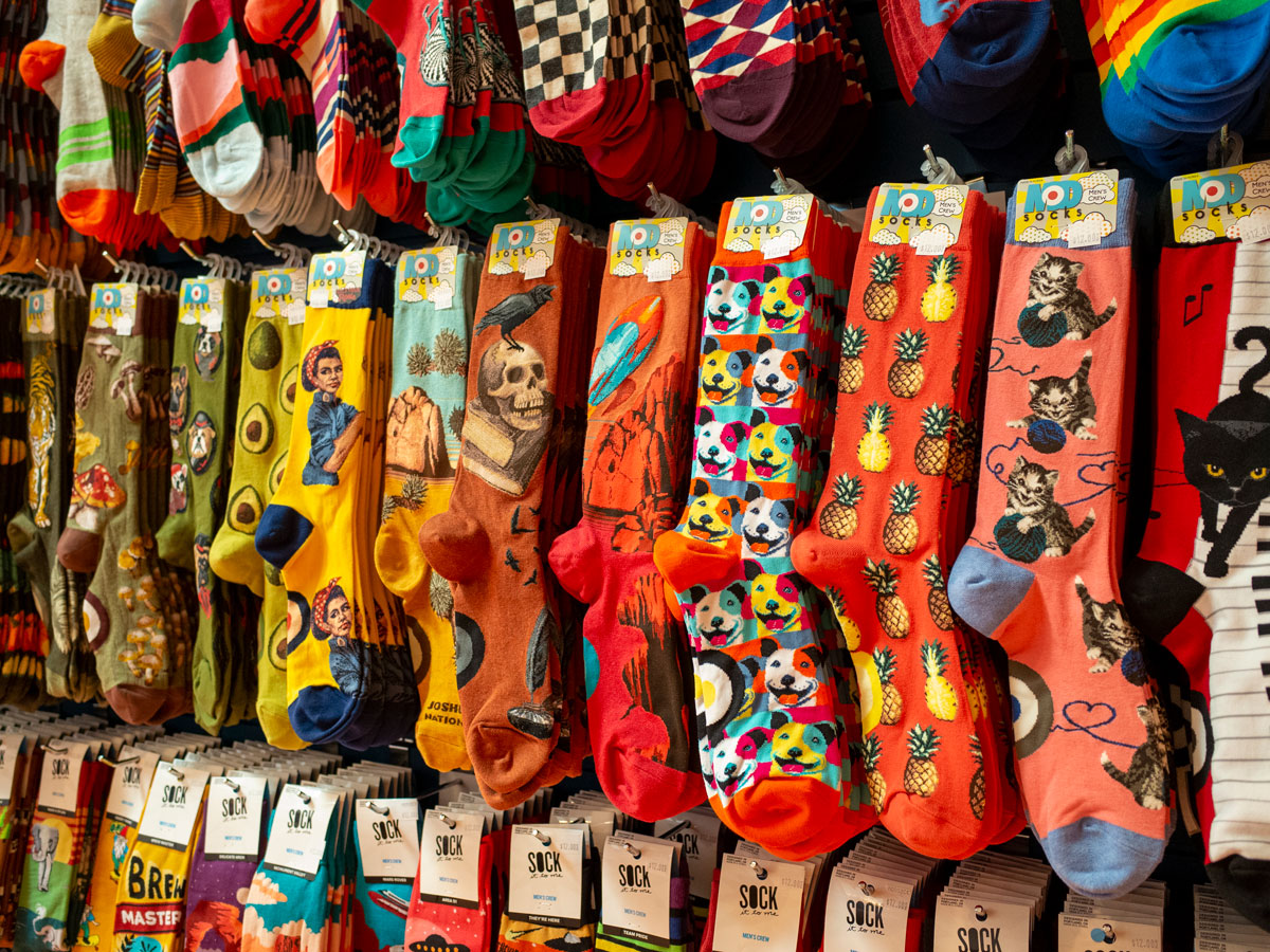 Lineup of colorful men's socks on a wall at Cute But Crazy Socks in Bellingham, Wash.