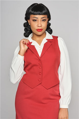 Elegant woman wearing red lipstick, a red waistcoat over an ivory 40s inspired blouse and red skirt