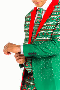 A man in The Kris Kringle Green Fair Isle Christmas Suit, embodying holiday magic at a festive gathering.