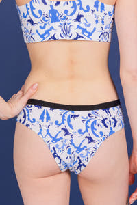 A close-up of The Risqué Rorschach | Blue Willow Cheeky Underwear on a woman's body.