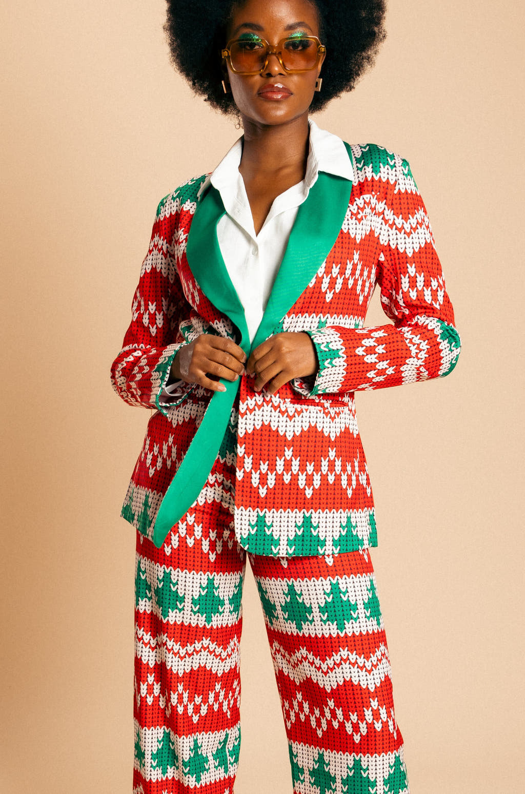 A woman in a festive knit blazer, part of The Red Ryder Christmas Suit collection by Shinesty.