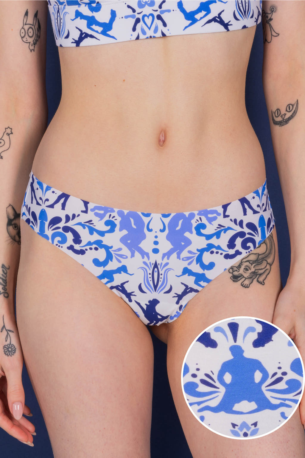 A woman's body with tattoos wearing The Risqué Rorschach | Blue Willow Seamless Thong.