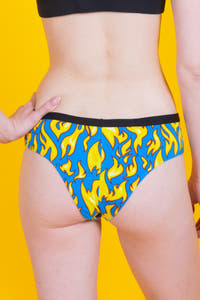 A close-up of The Fire Crotch | Flames Cheeky Underwear, featuring a person in blue and yellow undergarments.
