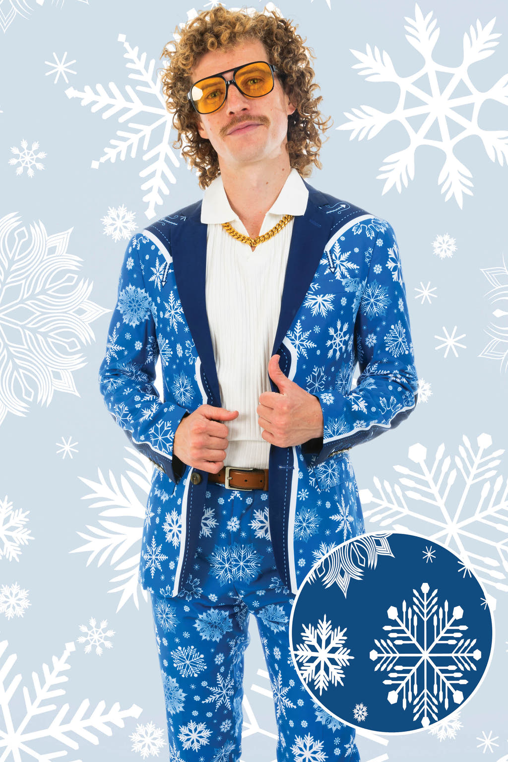 A man in a unique Christmas suit with snowflake designs, curly hair, and yellow sunglasses.