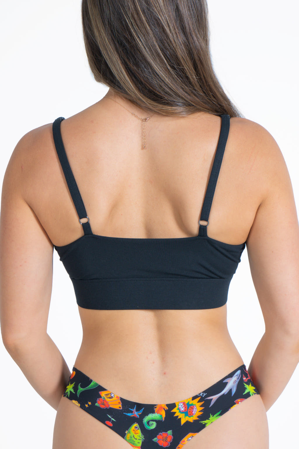 A woman in The Threat Level Midnight Black Strappy Bralette.