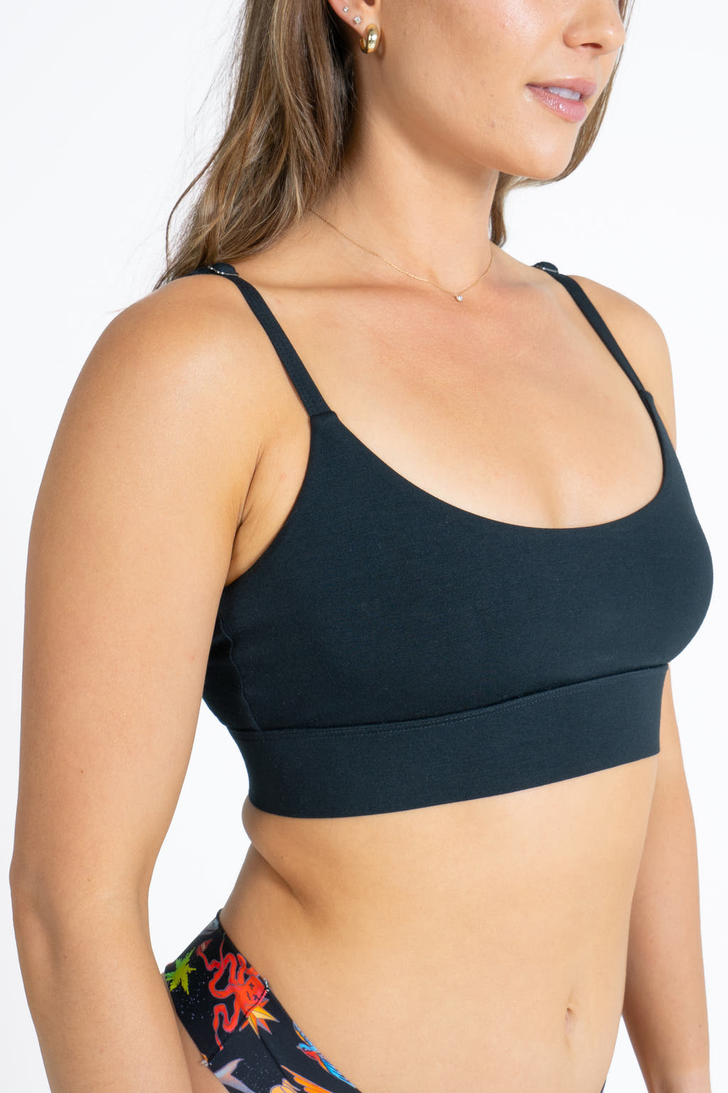 A close-up of The Threat Level Midnight Black Strappy Bralette on a woman's body.