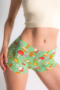 A woman wears The Trip Advisor | Mushroom Modal Boyshort Underwear, featuring whimsical mushroom pattern. Reflecting Shinesty's outlandish style with a fun, quirky design.