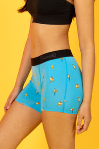 A person wearing Tweet Yourself Parrot Women’s Boxers with bird prints, embodying Shinesty's outlandish style.