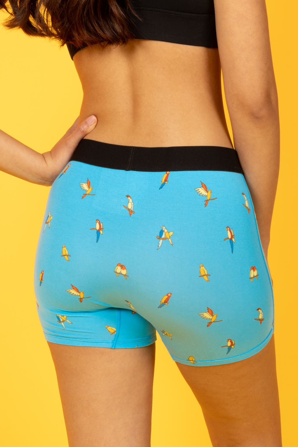 A person in The Tweet Yourself | Parrot Women’s Boxers, featuring birds, pondering bird sounds. From Shinesty's quirky collection.