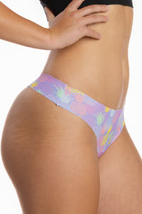 A close-up of The Juicy Fruit Pineapple Seamless Thong on a woman's body.