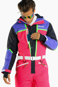 A man in a retro ski suit on the hill, ready for shredding.