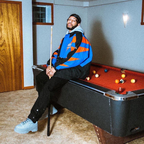 Person playing pool with a vintage outfit on