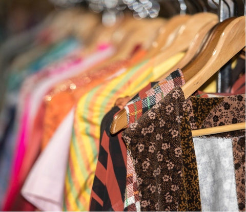 vintage clothing hanged on clothing rack